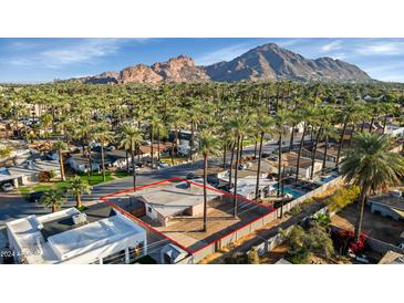 Aerial view of a single-story house with a large backyard, located in a residential neighborhood at 4301 E Roma Ave, Phoenix, AZ 85018