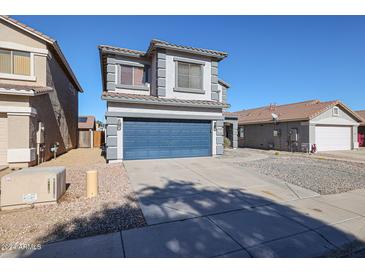 Two-story house with blue garage door and gravel driveway at 12926 W Bloomfield Rd, El Mirage, AZ 85335