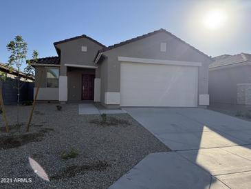 New single-story home with attached garage and desert landscaping at 17009 W Seldon Ln, Waddell, AZ 85355