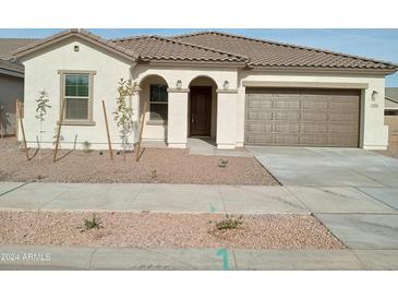 Newly constructed one-story home with a two-car garage and desert landscaping at 21026 E Calle Luna Ct, Queen Creek, AZ 85142