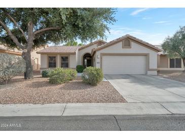 Single-story home with a two-car garage and desert landscaping at 3091 N 147Th Dr, Goodyear, AZ 85395