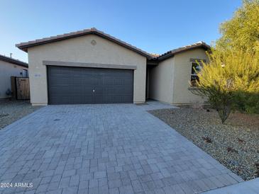 Single-story house with a two-car garage and neutral-colored exterior at 18128 N Bell Pointe Blvd, Surprise, AZ 85374