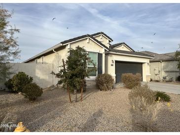 One-story home with a two-car garage and desert landscaping at 37776 W San Ildefanso Ave, Maricopa, AZ 85138