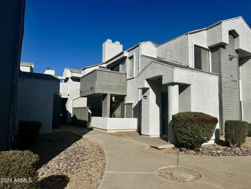Condo building exterior with walkway and landscaping at 9209 N 59Th Ave # 105, Glendale, AZ 85302