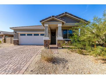 Single-story home with a two-car garage and landscaped front yard at 11980 S 173Rd Ave, Goodyear, AZ 85338