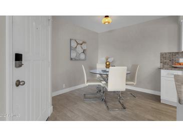 Bright dining area with glass table and four white chairs at 14645 N Fountain Hills Blvd # 114, Fountain Hills, AZ 85268