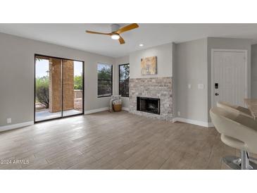 Living room features a fireplace and sliding glass doors to a patio at 14645 N Fountain Hills Blvd # 114, Fountain Hills, AZ 85268