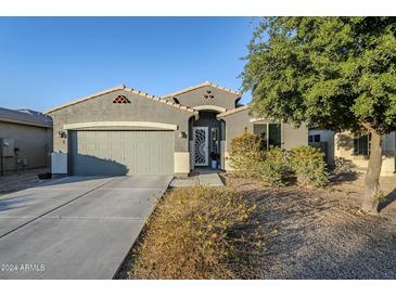 Single-story home with gray exterior, two-car garage, and landscaped front yard at 1792 W Loemann Dr, San Tan Valley, AZ 85144