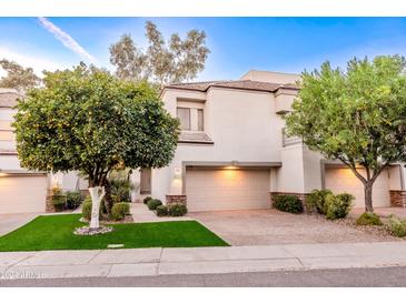 Attractive stucco home with two-car garage and lush landscaping at 7272 E Gainey Ranch Rd # 75, Scottsdale, AZ 85258