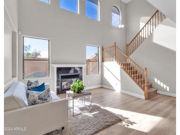 Bright living room with high ceilings, fireplace, and hardwood floors at 125 N 22Nd Pl # 30, Mesa, AZ 85213