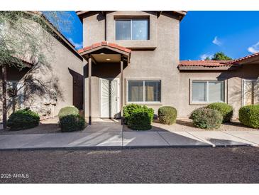 Two-story stucco home with a covered entryway and landscaped front yard at 17610 N 17Th Pl # 6, Phoenix, AZ 85022