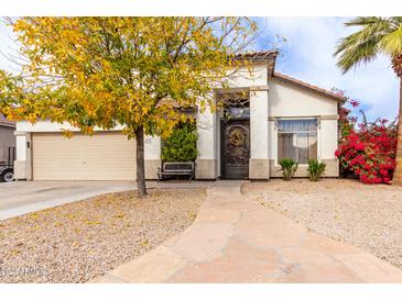 Inviting single-story home with landscaped front yard and a charming entryway at 3470 E Wildhorse Dr, Gilbert, AZ 85297