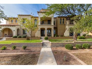 Two-story stucco home with Spanish-style architecture and landscaped grounds at 4312 N Verrado Way, Buckeye, AZ 85396