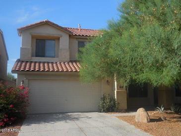 Two-story house with tan exterior, tile roof, and attached garage at 45638 W Dirk St, Maricopa, AZ 85139