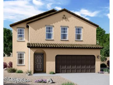 Two-story house with tan exterior, brown garage door, and landscaping at 5817 W Moody Trl, Laveen, AZ 85339