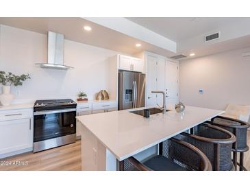 Modern kitchen with stainless steel appliances and white cabinetry at 3131 N Central Ave # 5022, Phoenix, AZ 85012