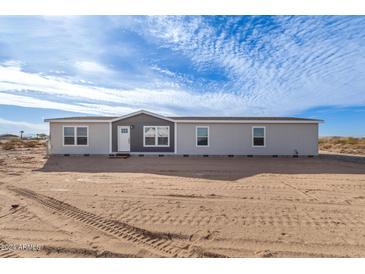 Single-story home with neutral siding and landscaping at 35041 W Euclid Ave, Tonopah, AZ 85354