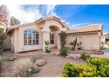 Single-story home with landscaped front yard, inviting walkway, and two-car garage at 1409 W Maria Ln, Tempe, AZ 85284