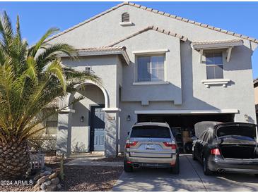 Two-story house with gray siding, attached garage, and palm trees at 19182 N Smith Dr, Maricopa, AZ 85139