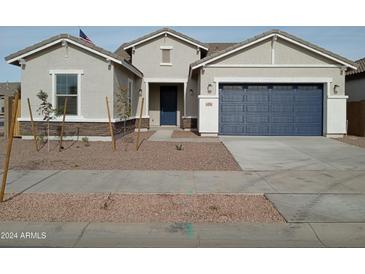 One-story house with a two-car garage and desert landscaping at 21018 E Calle Luna Ct, Queen Creek, AZ 85142