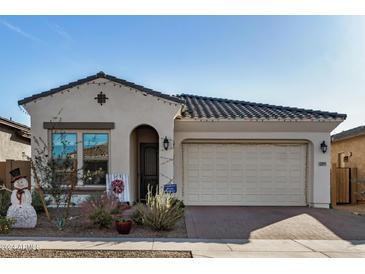 One-story home with a two-car garage and landscaped front yard at 22811 E Stacey Rd, Queen Creek, AZ 85142