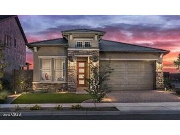 Stunning craftsman style home with a two-car garage and landscaped front yard at 26032 S 229Th Pl, Queen Creek, AZ 85142