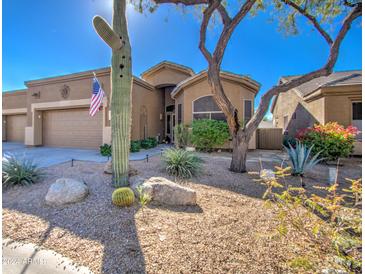 Front view of a tan house with cacti and desert landscaping at 7143 E Canyon Wren Dr, Gold Canyon, AZ 85118