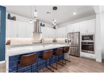 Modern kitchen featuring stainless steel appliances and a large island at 1310 E Beechnut Pl, Chandler, AZ 85249