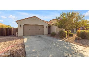 Single-story house with a two-car garage and well-maintained landscaping at 2008 E Stacey Rd, Gilbert, AZ 85298