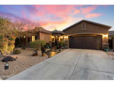 Inviting single-story home with desert landscaping and attached two-car garage at 2317 W Horsetail Trl, Phoenix, AZ 85085