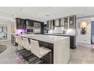 Modern kitchen with stainless steel appliances and breakfast bar at 7137 E Rancho Vista Dr # 3006, Scottsdale, AZ 85251