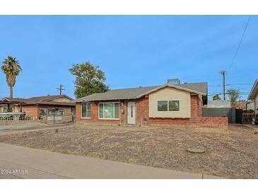 Charming single-story home with brick exterior and front yard at 4238 W Krall St, Phoenix, AZ 85019