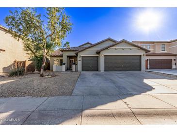 Single-story house with two-car garage and landscaped front yard at 5415 W Novak Way, Laveen, AZ 85339