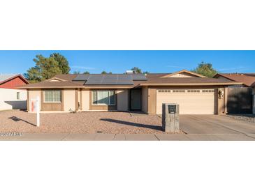 Ranch style home with solar panels and a two-car garage at 14821 N 51St Dr, Glendale, AZ 85306
