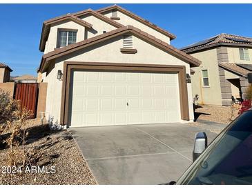 Two-story house with attached garage and desert landscaping at 22262 W Tonto St, Buckeye, AZ 85326