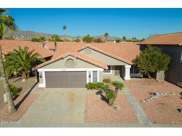 Single-story home with tile roof and two-car garage at 2306 E Desert Trumpet Rd, Phoenix, AZ 85048