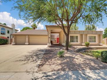 Beautiful home with a three-car garage and mature landscaping at 420 N Benson Ln, Chandler, AZ 85224