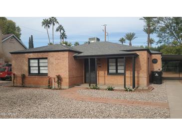 Charming brick home with a covered porch and landscaped yard at 1540 E Cheery Lynn Rd, Phoenix, AZ 85014