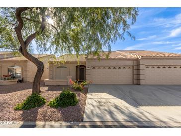 Tan two-story house with double garage and landscaped yard at 2101 S Yellow Wood -- # 89, Mesa, AZ 85209