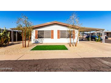 House exterior featuring a carport and landscaping at 245 S 56Th St # 75, Mesa, AZ 85206