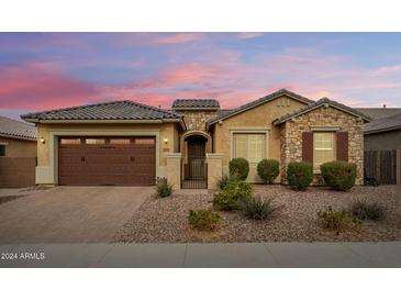 Single-story home with a two-car garage and desert landscaping at 2456 E Lindrick Dr, Gilbert, AZ 85298