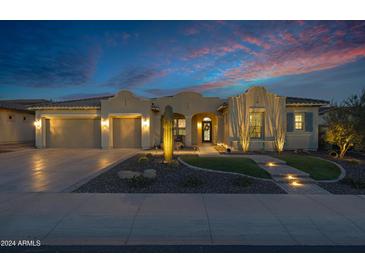 Single-story home with a three-car garage, desert landscaping, and walkway at 30807 N 117Th Dr, Peoria, AZ 85383