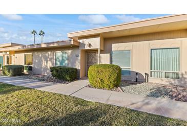 Single-story home exterior with a welcoming front entrance and landscaped yard at 13027 N 99Th Dr, Sun City, AZ 85351