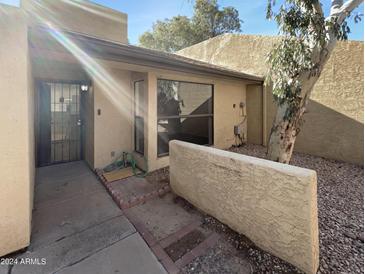 Front yard of a two-story home with a walkway, landscaping, and a tree at 3228 W Glendale Ave # 118, Phoenix, AZ 85051
