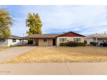 Charming single-story home with a carport and front yard at 453 S Miller St, Mesa, AZ 85204