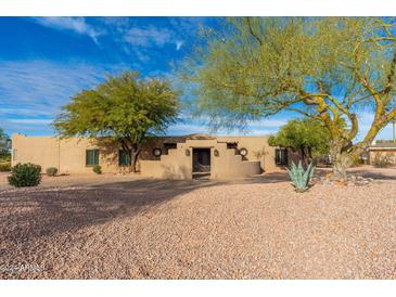 Spanish style home with landscaped front yard and gated entry at 12550 E Silver Spur St, Scottsdale, AZ 85259
