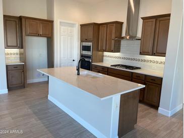 Modern kitchen featuring wood cabinets, large island, stainless steel appliances, and tile flooring at 5640 W Bullhead Rd, Eloy, AZ 85131