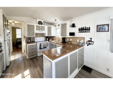 Functional kitchen with a peninsula, modern appliances, and plenty of storage at 99 S Kaoline Dr, Apache Junction, AZ 85119