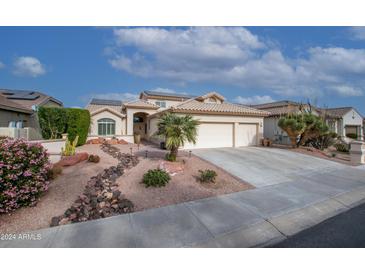 Two-story house with desert landscaping, two-car garage, and solar panels at 16068 W Edgemont Ave, Goodyear, AZ 85395