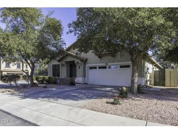 Charming single-story home with a two-car garage and landscaped front yard at 3018 N Regal Ct, Casa Grande, AZ 85122